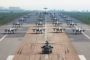 U.S. military planes lined up in formation on a tarmac.