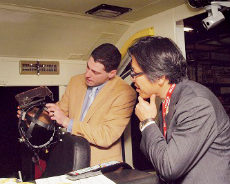 atthew Isaacs of Volpe explains findings to Dr. Masateru Ikehata from recent rail simulator research, conducted for FRA. (Volpe photo)