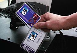Close-cropped image of someone holding the University of Washington's student ID cards, the Husky card.