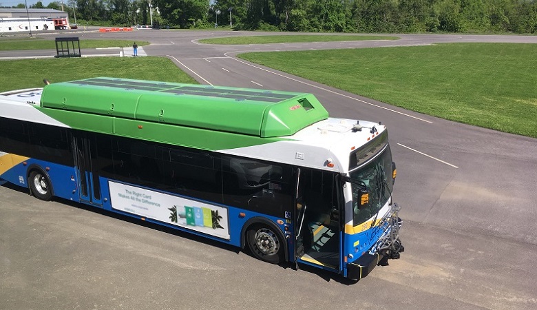 A transit bus, equipped with an emergency braking feature, parked at the Virginia Tech Transportation Institute (VTTI) Smart Road test track, where it underwent testing during spring 2019. (Joshua Cregger/U.S. DOT Volpe Center photo)