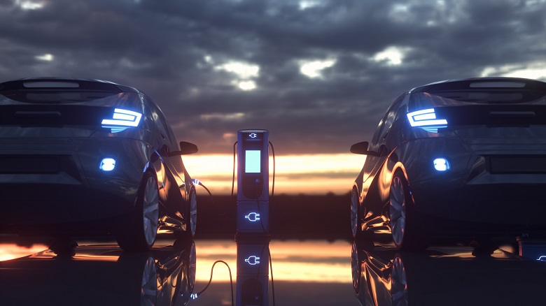 Two electronic cars charging at a charging station