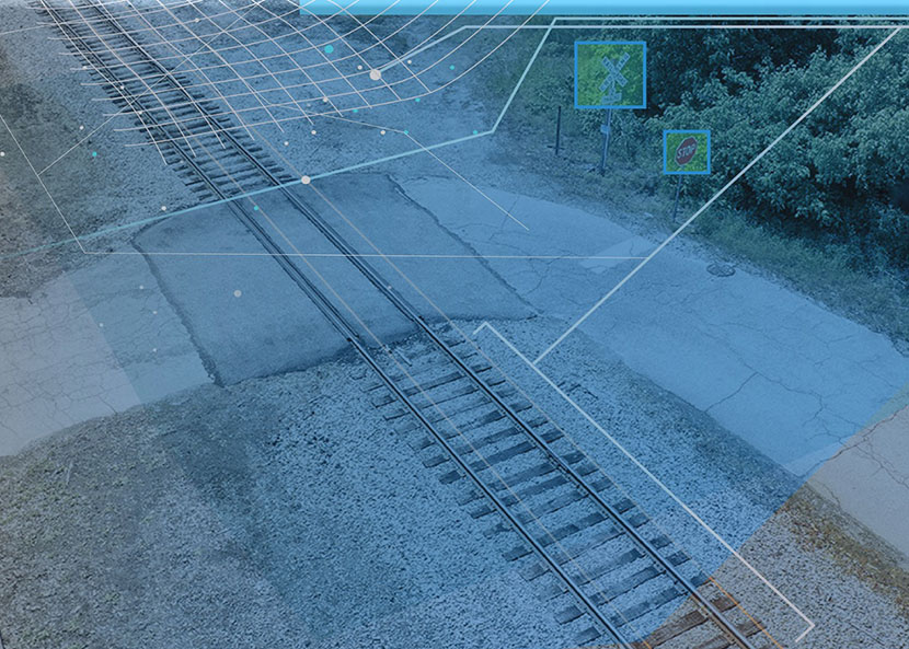 A photo of a highway-rail grade crossing with graphical overlays that indicate the crossing's height and zero-in on crossing signage.