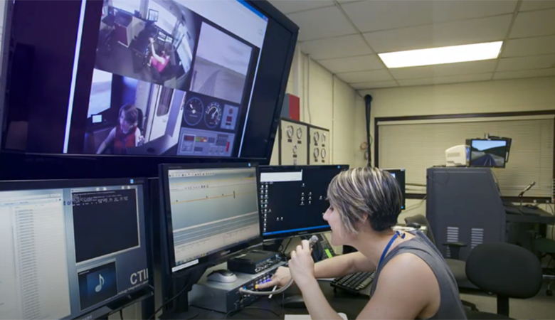A woman working in the CAB Technology Integration Laboratory Control Room