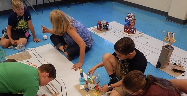 Students assemble robotic car parts during an after-school STEM class. (NanoSonic photo) 