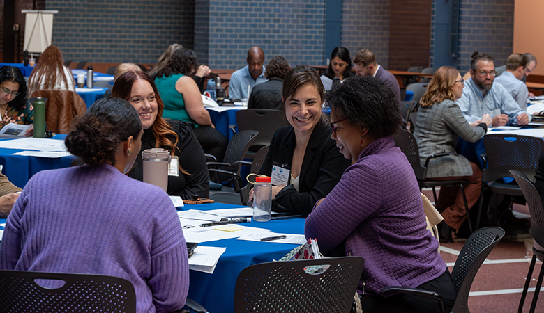 Image shows table of community members collaborating on plan-based technical assistance.