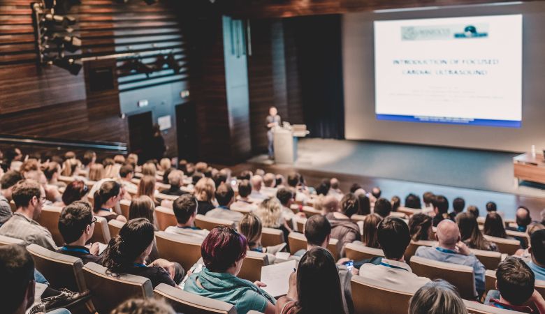 Professor addressing students in lecture hall