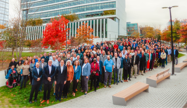 all staff photo in front of building 