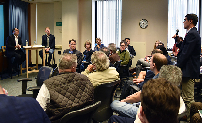 An audience member asks Derek Kan and Kyle Vogt a question