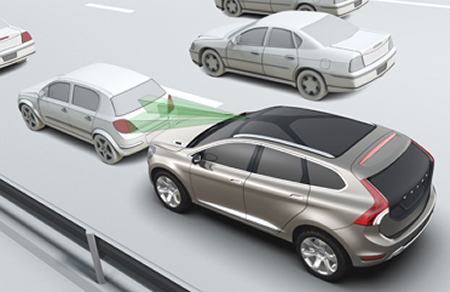 A Volvo that uses crash-avoidance technology slows as the car in front of it stops.
