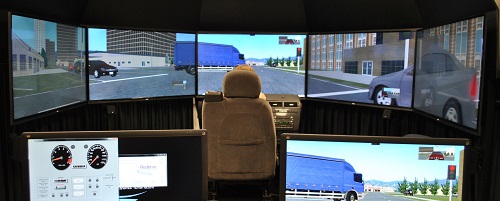 A woman sits in the driver's seat of Volpe's new driving simulator.