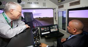 Volpe human factors engineer John K. Pollard talks with the Secretary about how our rail simulator contributes to human factors research.(Linda Haas Photography photo)