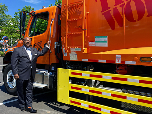 Greg Winfree stands next to a Cambridge Department of Public Works truck outfitted with side guards.