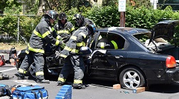 Firefighters use the Jaws of Life to cut into a car