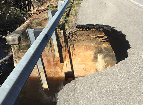 Part of a road is destroyed as a result of the heavy rains from Hurricane Matthew. (Volpe photo) A large hole has opened up and collapsed in the pavement on the shoulder of a highway.