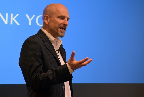 During his talk at Volpe, Jeffrey Schnapp presented a concept prototype for a cargo pod on wheels that can carry items like luggage or groceries, turn on a dime, follow its owner, and autonomously travel to different locations. Jeffrey Schnapp speaks to a crowd at U.S. DOT"s Volpe Center.