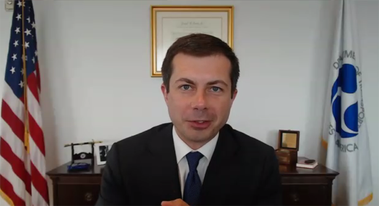 Secretary Pete Buttigieg speaks via videoconference from his office.