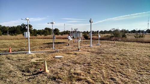 Volpe is testing new sensors that can automatically identify intermediate precipitation and help the aviation community negotiate poor weather. Image of weather research sensors in a field