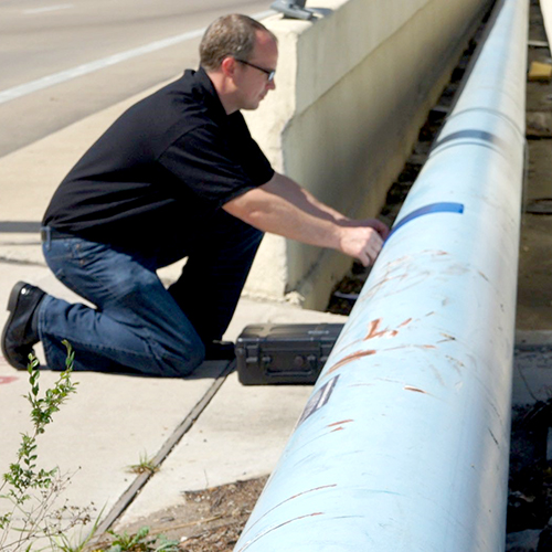 A man tests a pipeline.