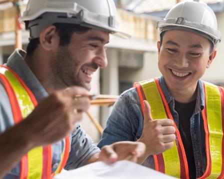 An image of two coworkers discussing a construction plan.