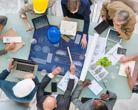 An image of workers studying a construction plan.