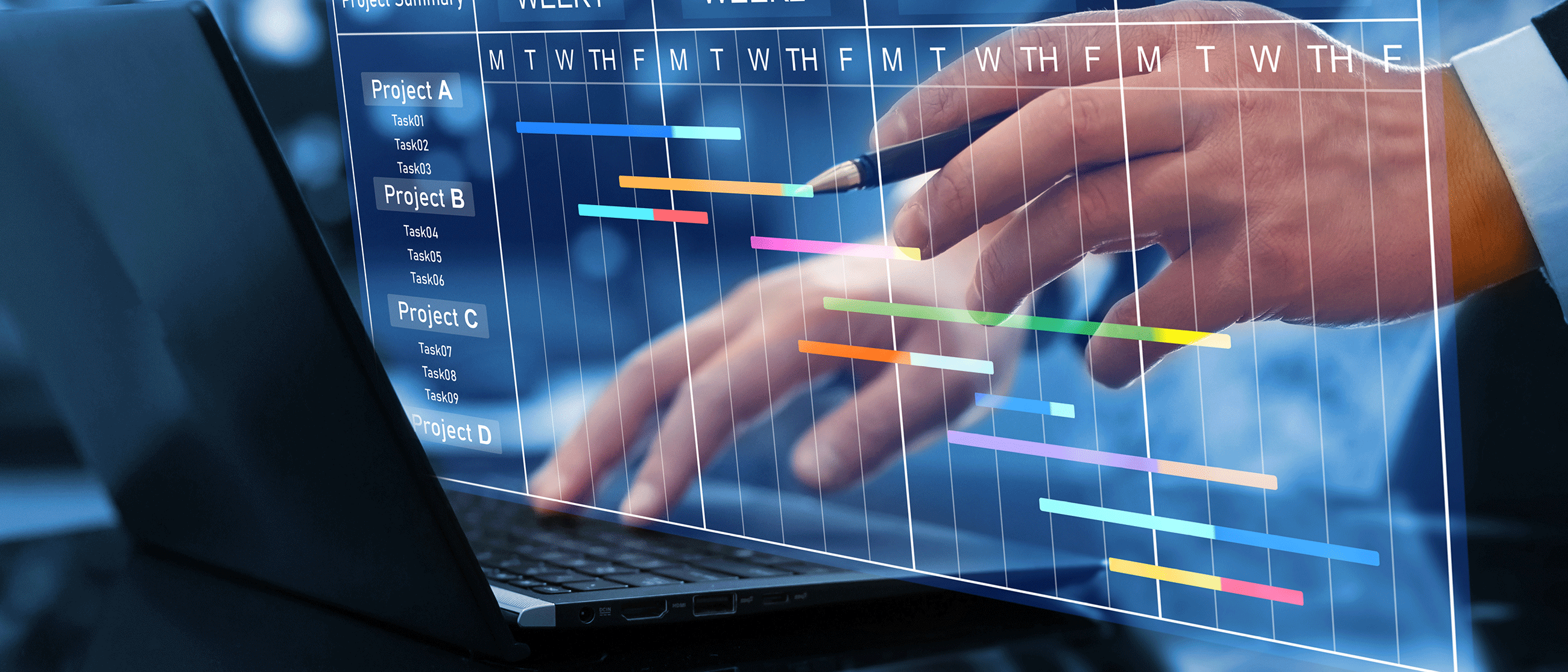 Hands typing a long a laptop and looking at a weekly calendar