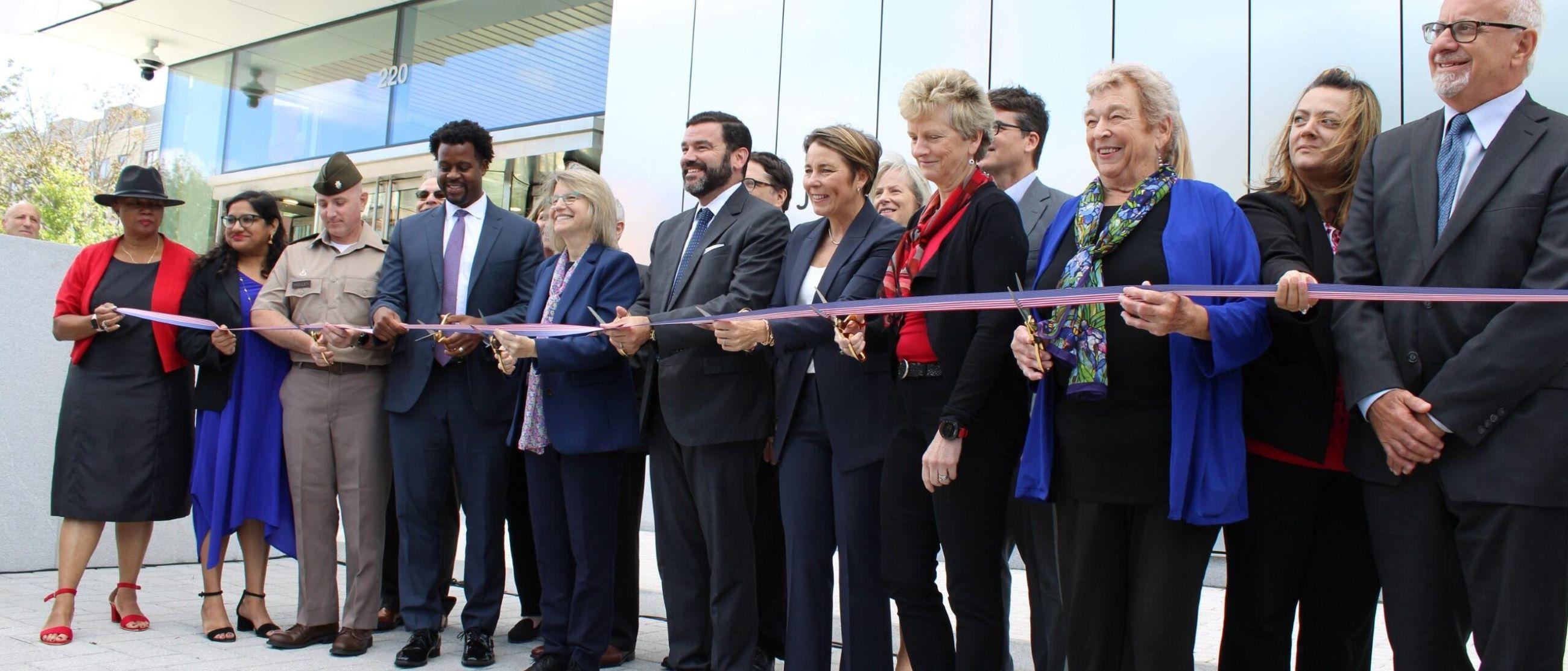 Image of U.S. DOT leadership, state and local leaders, and redevelopment Volpe Exchange Partners cut the ribbon to officially mark the opening of the new U.S. DOT Volpe Center facility in Cambridge, MA’s Kendall Square.