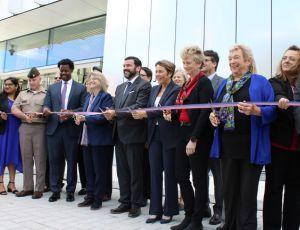Image of U.S. DOT leadership, state and local leaders, and redevelopment Volpe Exchange Partners cut the ribbon to officially mark the opening of the new U.S. DOT Volpe Center facility in Cambridge, MA’s Kendall Square