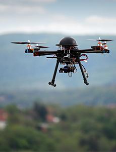 drone flying above grass
