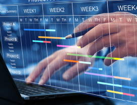 A person on a laptop looking at a work calendar