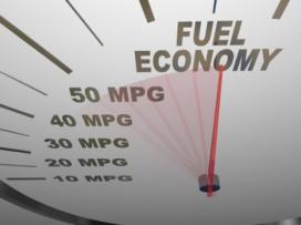 Fuel economy on a speedometer with a red needle racing past numbers