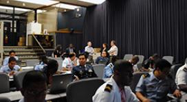 Image of maritime and military personnel in a meeting room