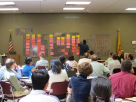A group of people meeting in a large conference room.