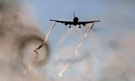 A jetliner leaving behind distinct wake vortices, shown with smoke, during a wake turbulence test.