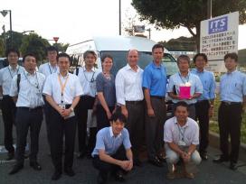 Volpe transportation planner Elizabeth (Eli) Machek (at center) joined other members of the U.S.-Japan ITS Task Force at Shonan Parking Area in Chiba Prefecture, Japan, to view the installation of an ITS Spot dedicated short-range communications roadside unit. Pictured here with Machek are MLIT officials, Kashiwa City officials, and Brian Cronin and Dale Thompson of ITS JPO. (Volpe photo) Group photo of members of the U.S.-Japan ITS Task Force at Shonan Parking Area in Chiba Prefecture, Japan, to view the installation of an ITS Spot dedicated short-range communications roadside unit.